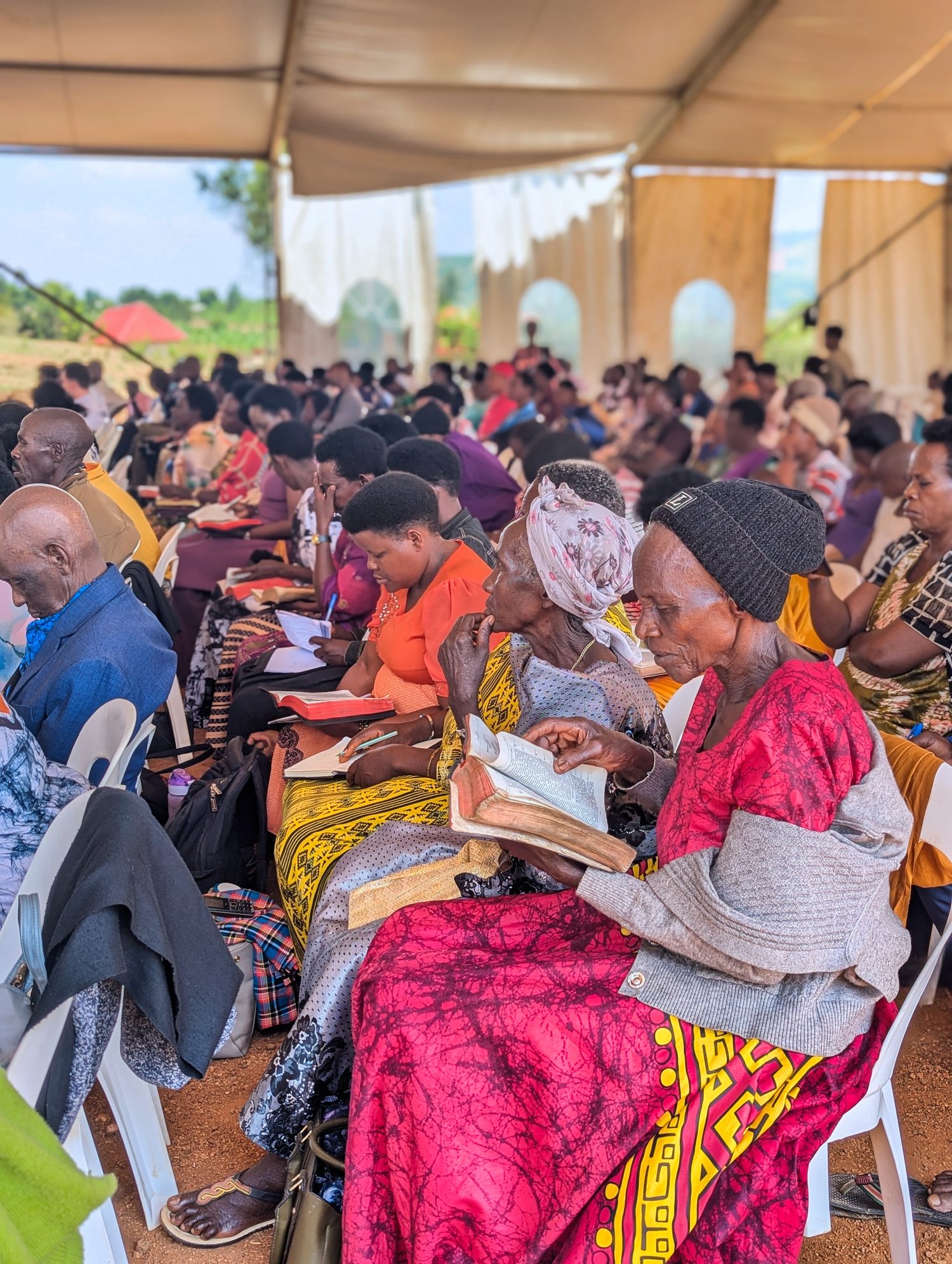 Attendees following the teaching with open Bibles and notebooks.